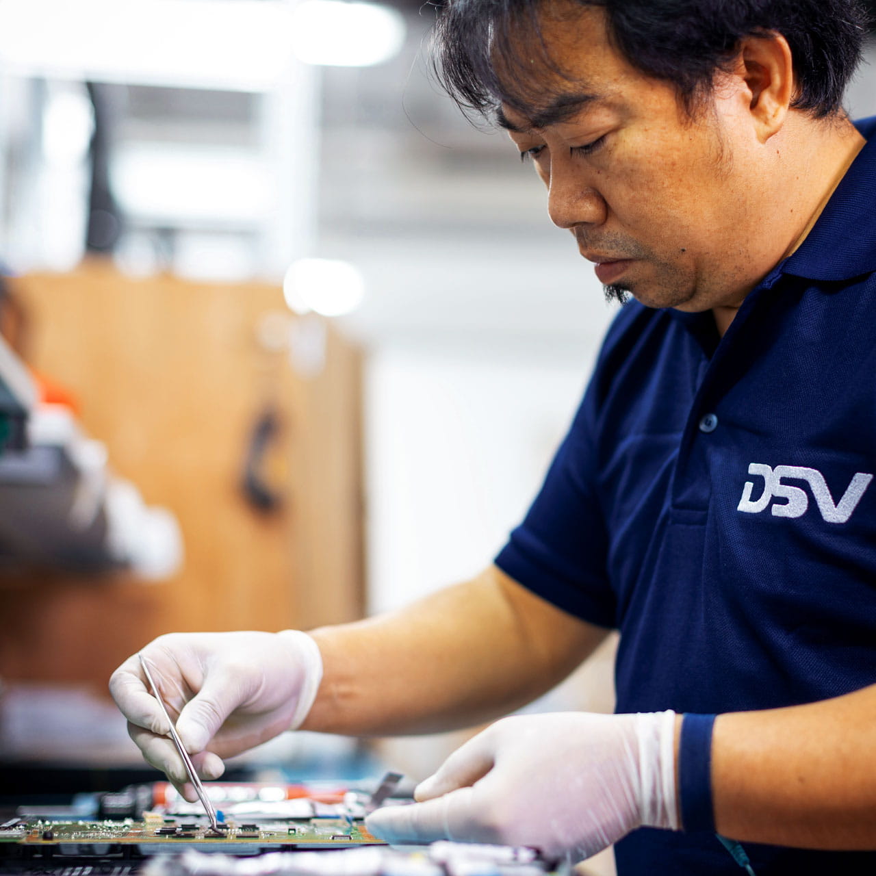 Male asian warehouse worker with white gloves